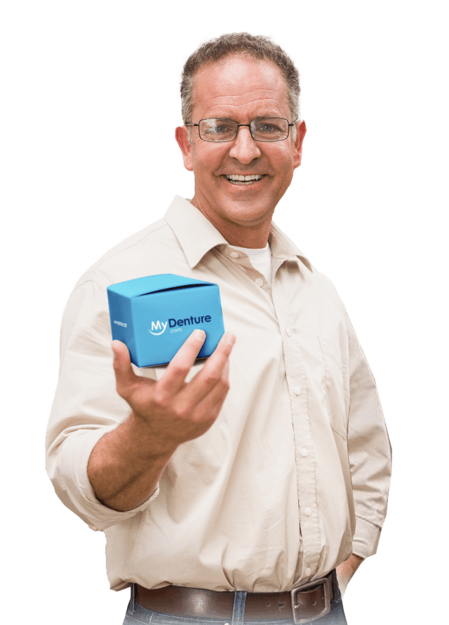 Man smiling and holding a box